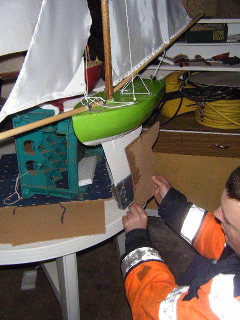 Douglas checks the keel of his latest boat against the template. Photo: SR